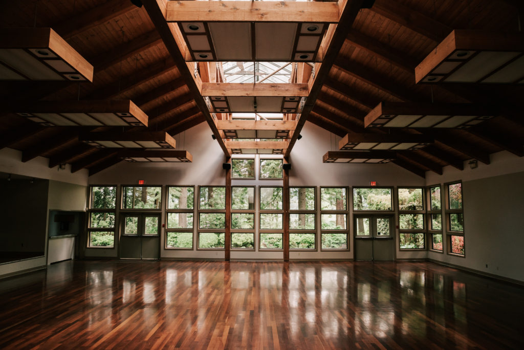 Gleaming hardwood floors and cathedral windows of the Whonnock Lake Wedding Venue banquet hall