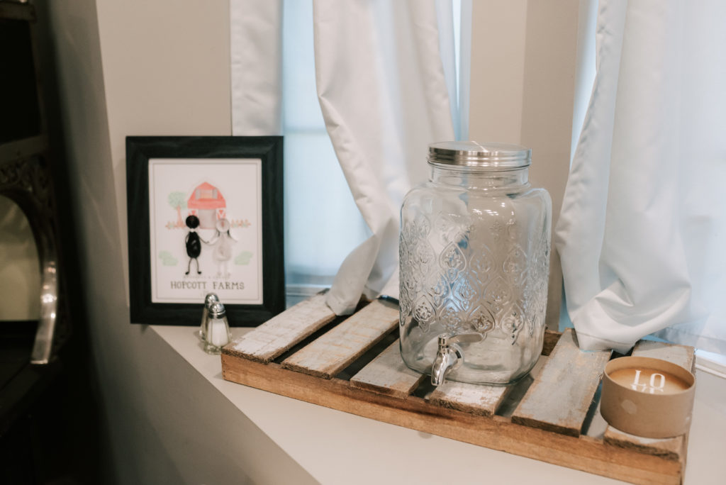 Sweet bridal suite details including mason jar drink dispenser, candles and rustic touches