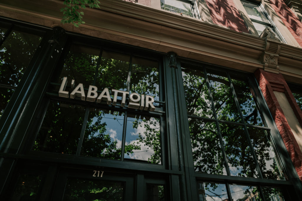 L'Abattoir alternative wedding venue entrance sign above glass windows in Vancouver