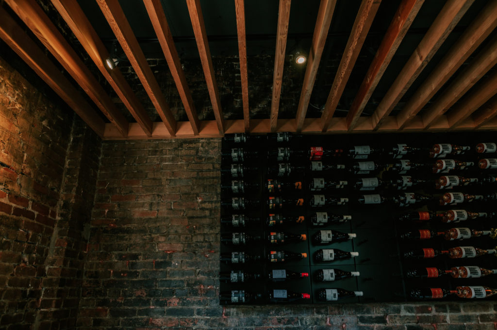 A view of the wine rack against brick walls inside L'Abattoir's private dining room